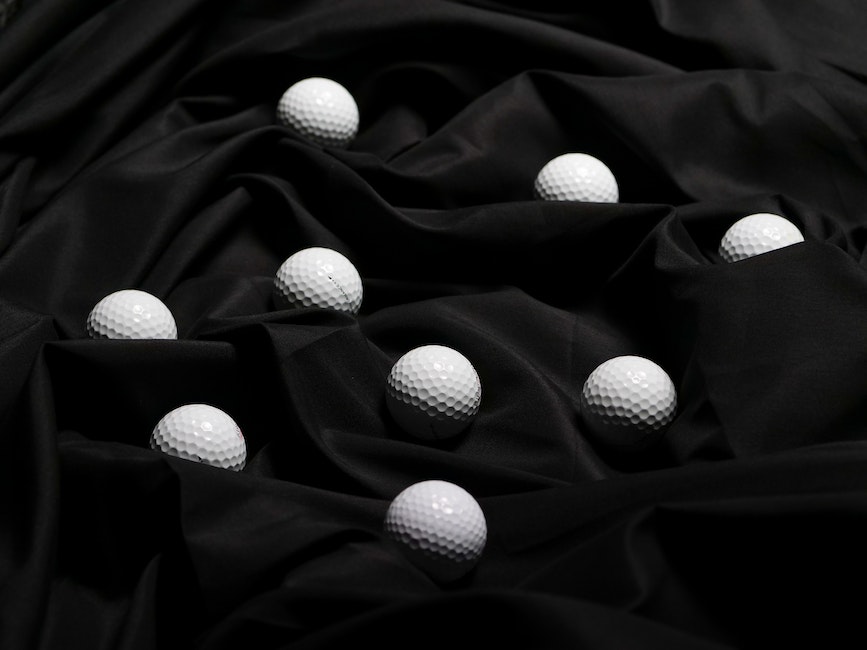 Pieces of Black Golf Balls on Top of Black Fabric